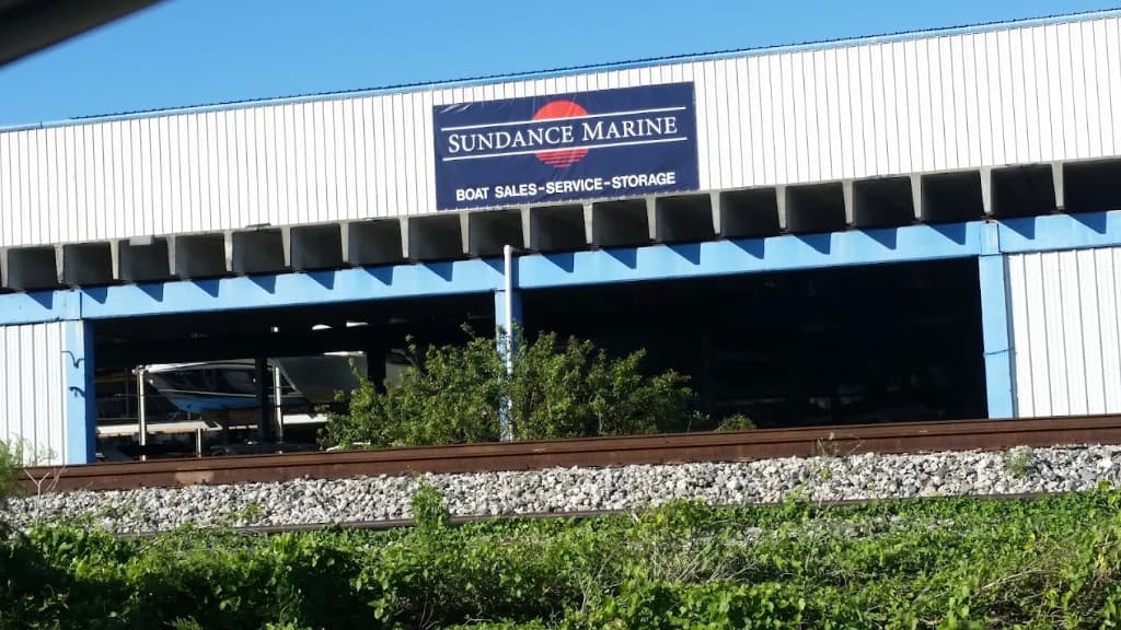 Sundance Marine boat sales, service, and storage sign on a South Florida boat storage building