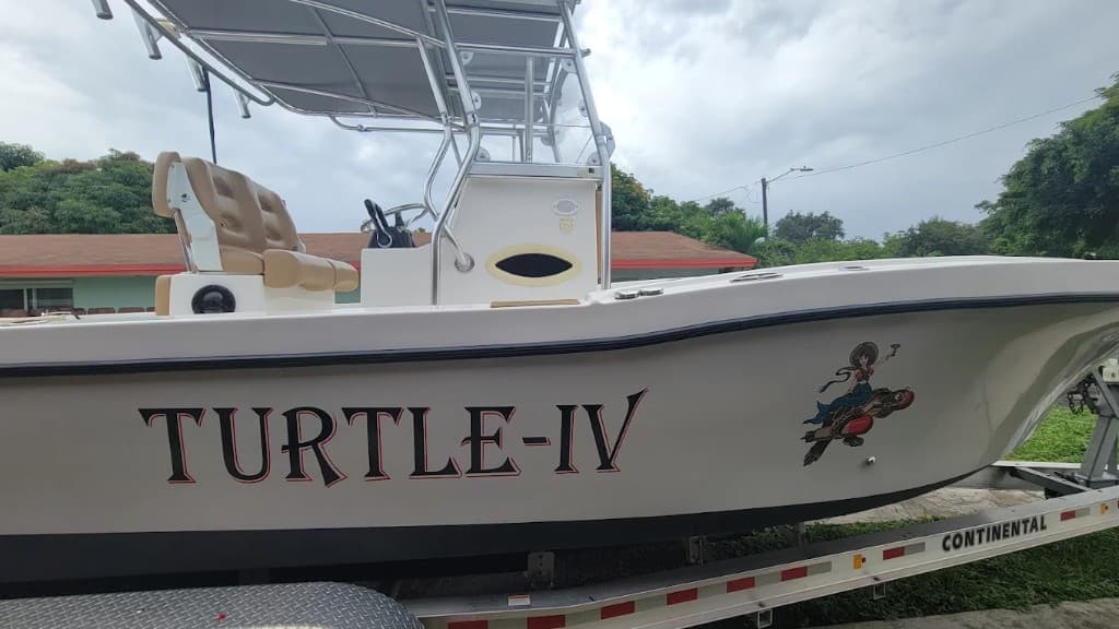 TURTLE-IV hull lettering with a mermaid graphic on a white center console
